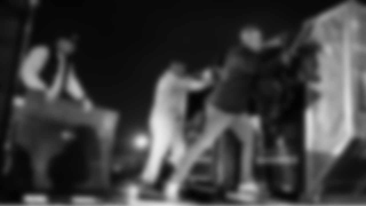 Upon arrival on Saturday, members of the Seahawks equipment staff Austin Bui, Rick Rainwater and Dan Cramer unload cases of equipment from the plane to be brought to the stadium.