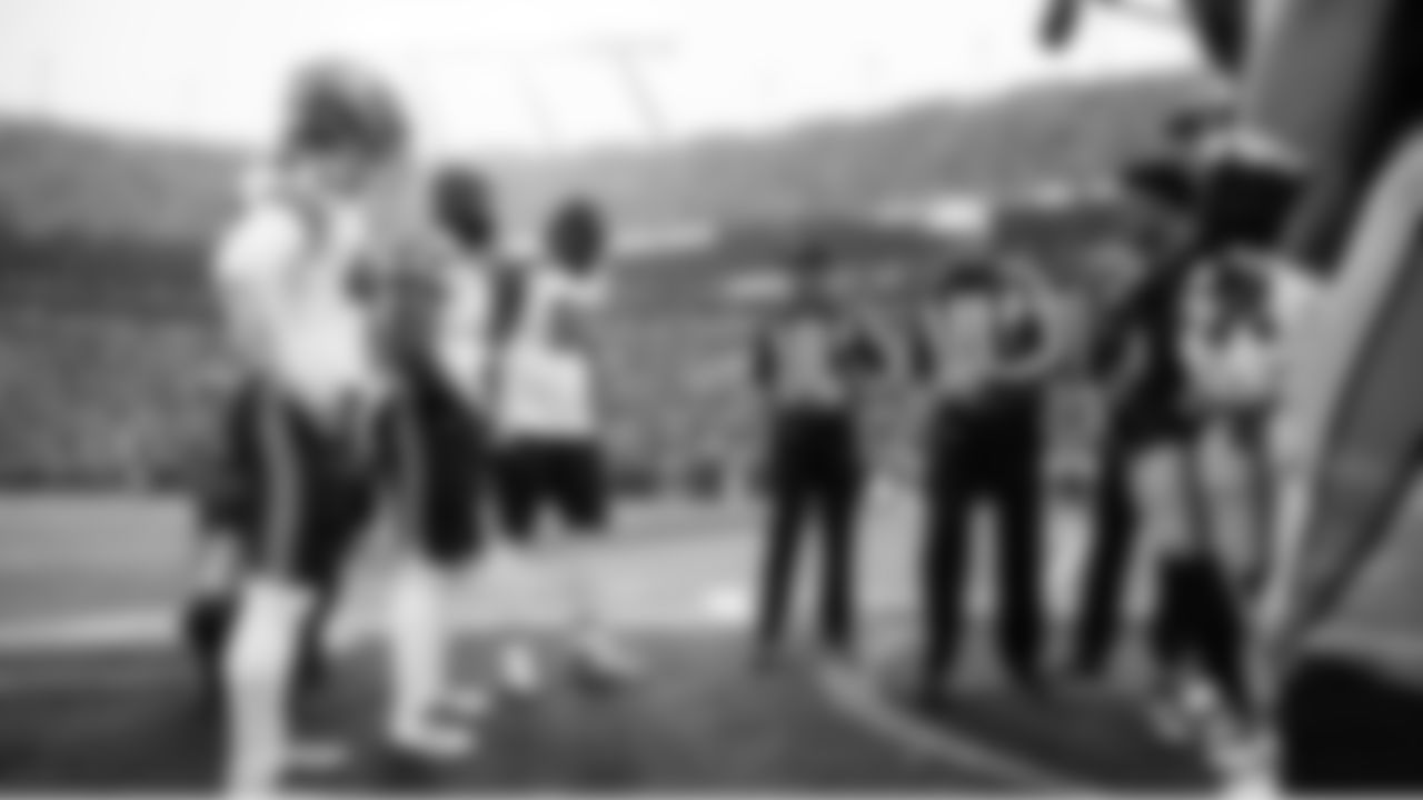 Seahawks game captains Drake Thomas, Kenneth Walker III and Jarran Reed at midfield for the coin toss.