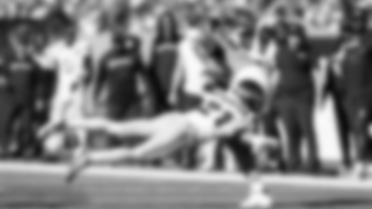 Seahawks cornerback Devon Witherspoon makes a flying tackle before halftime.