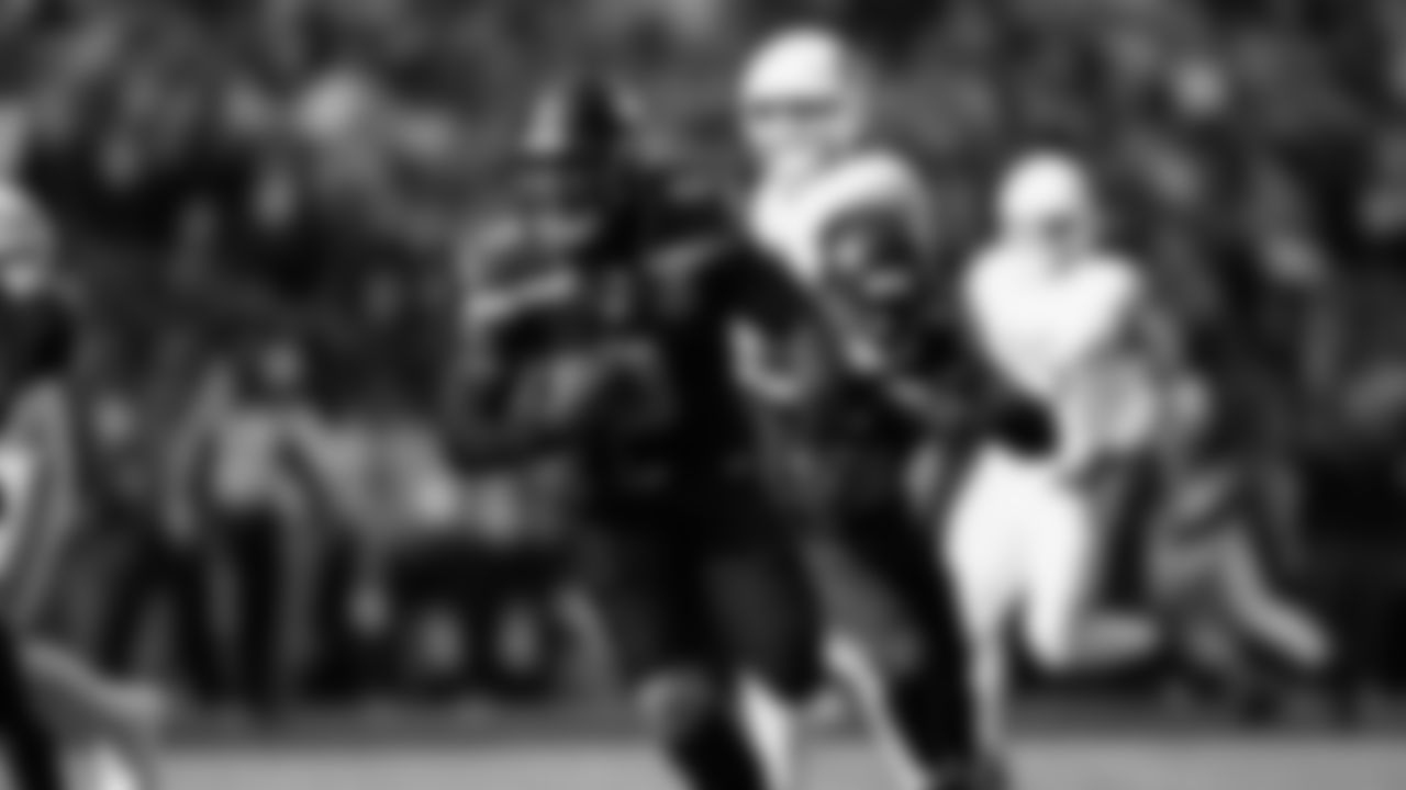 Seahawks linebacker Tyrice Knight (48) sacks Cardinals QB Jacoby Brissett and defensive end DeMarcus Lawrence (0) scoops the ball up and scores the touchdown.