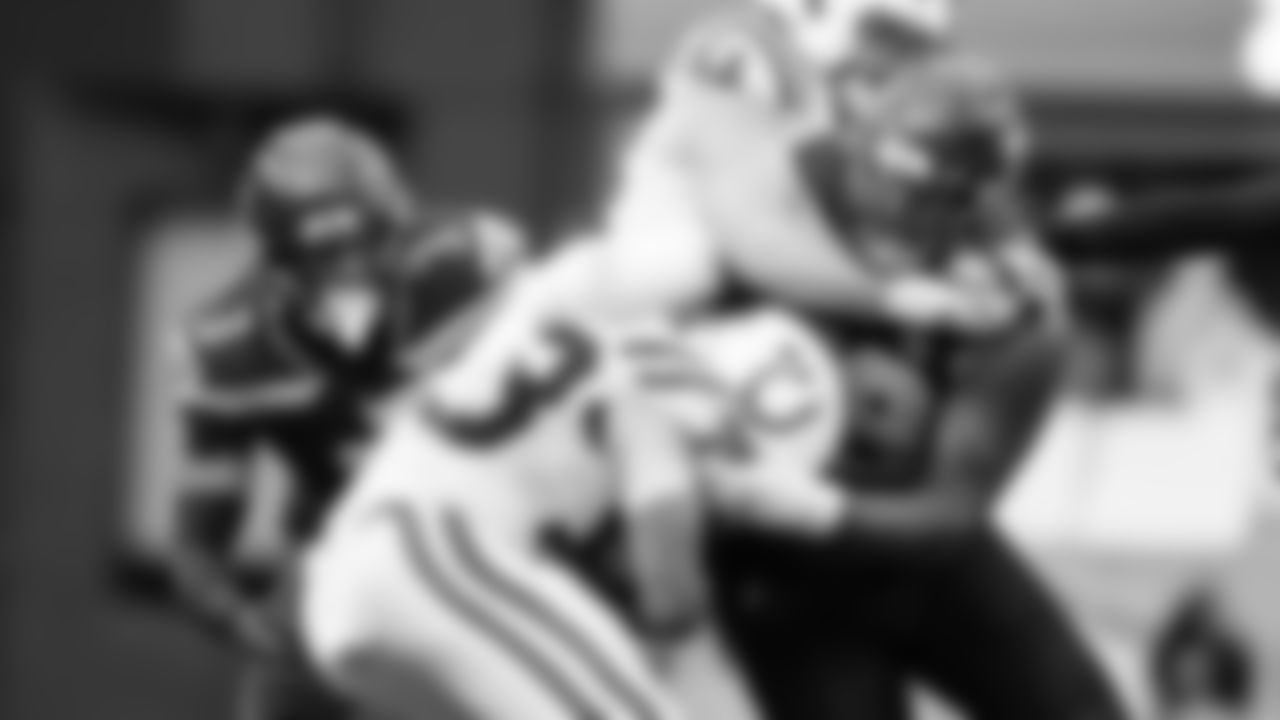 Seattle's Leonard Williams doesn't let a Colts lineman deter him from making a tackle as teammate Nick Emmanwori closes in.