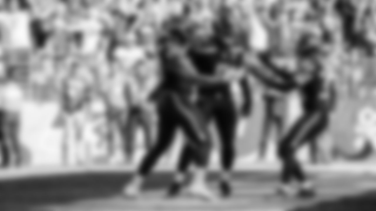 Seahawks linebacker Tyrice Knight (48) sacks Cardinals QB Jacoby Brissett and defensive end DeMarcus Lawrence (0) scoops the ball up and scores the touchdown.