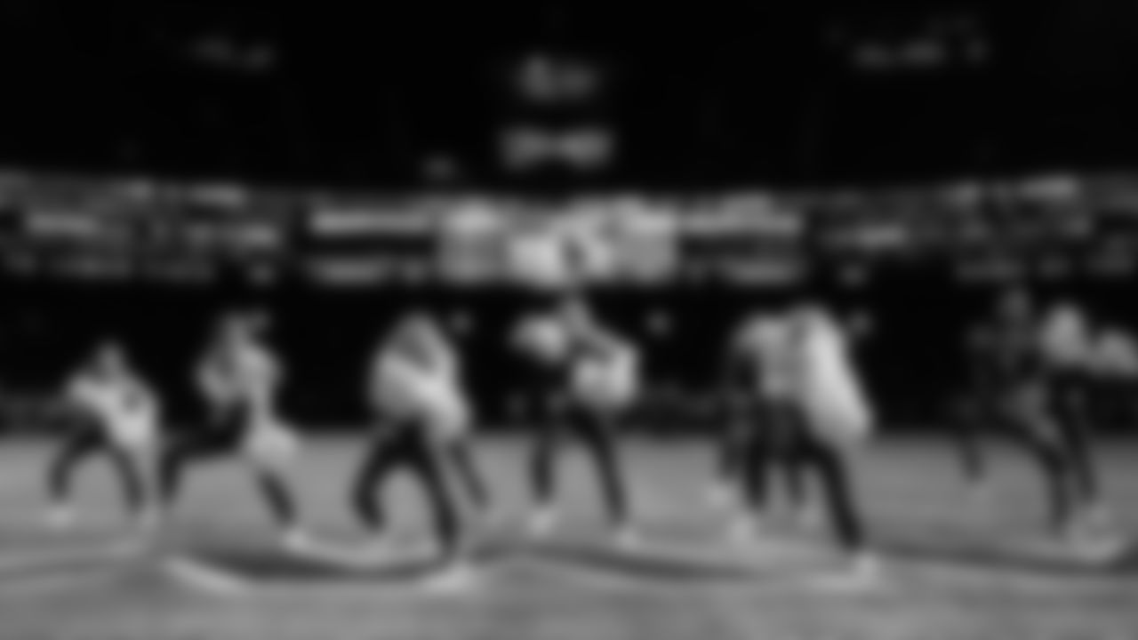 The Seahawks Dancers perform in a darkened stadium during Monday Night Football.