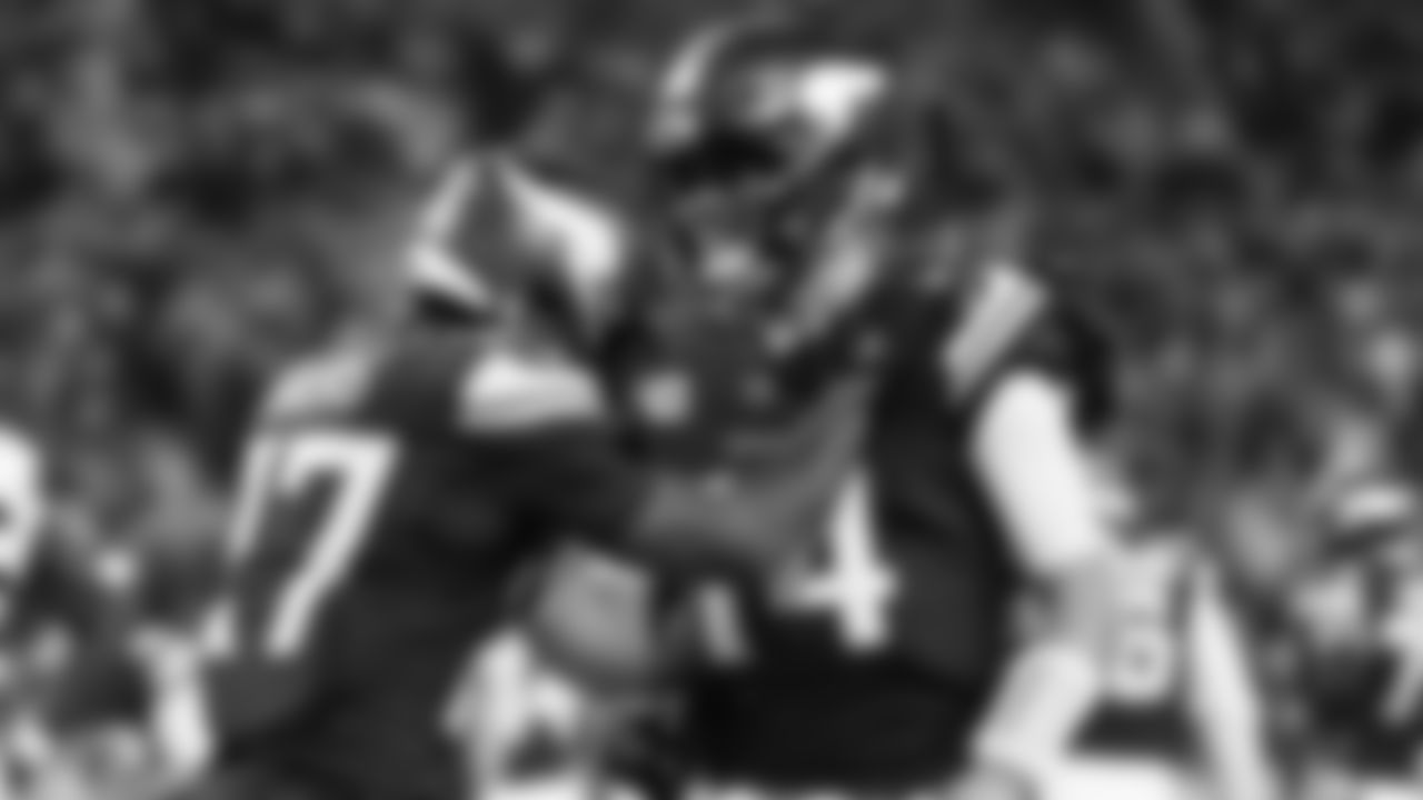 Minnesota Vikings' Sam Darnold congratulates Cam Akers on a touchdown catch during the second half of an NFL football game against the Green Bay Packers Sunday, Dec. 29, 2024, in Minneapolis. (AP Photo/Bruce Kluckhohn)