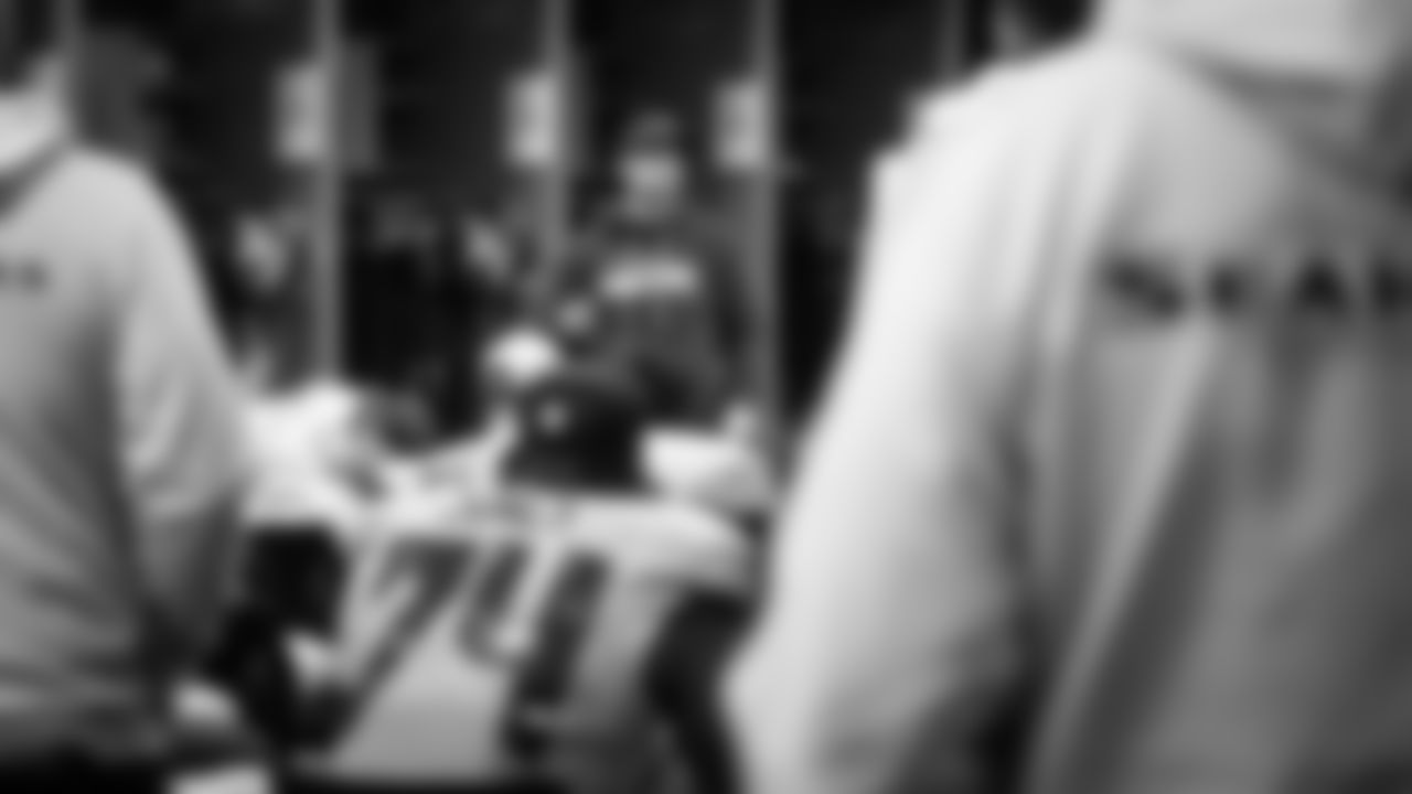 At halftime, offensive coordinator Klint Kubiak talks to his players.