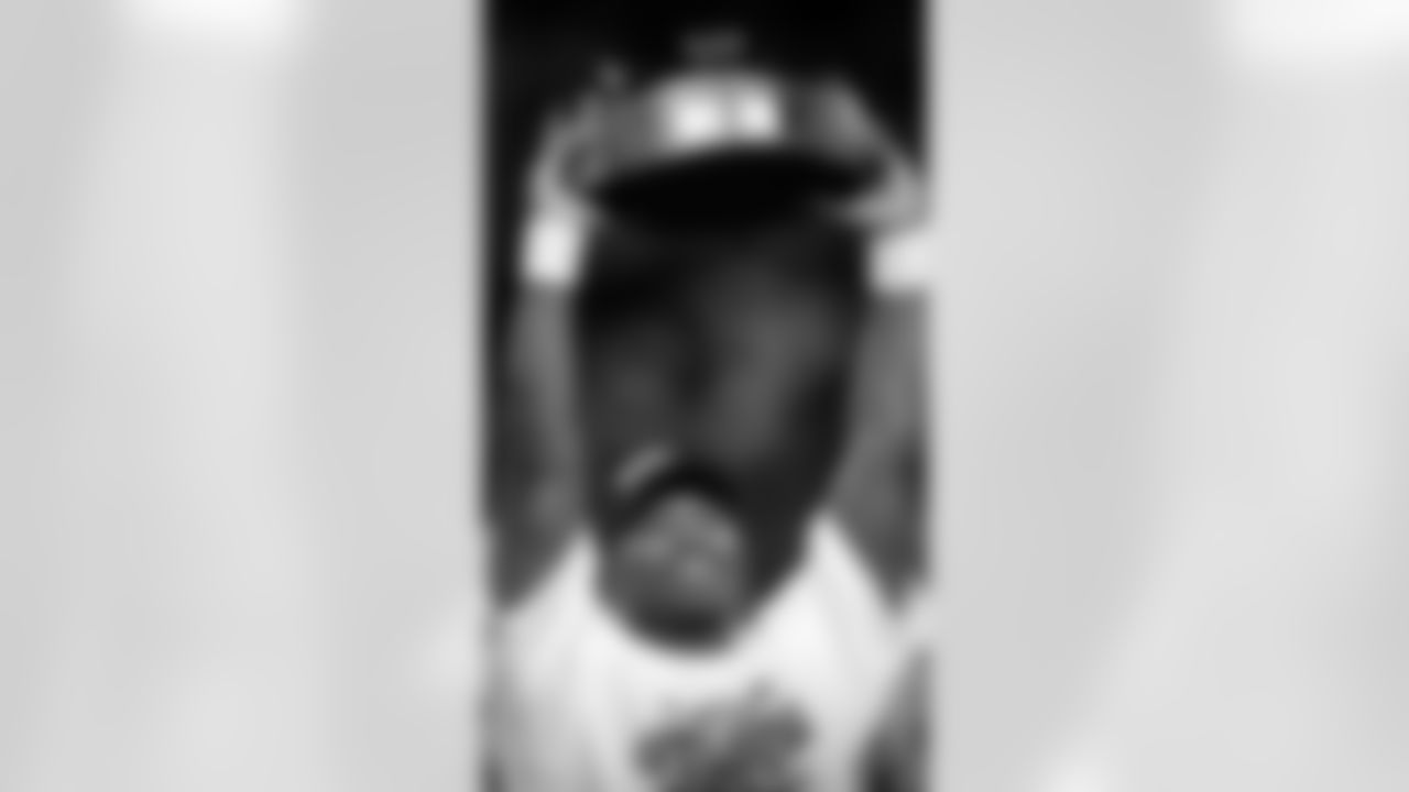 In this Jan. 22, 2006 file photo, Seattle Seahawks' Shaun Alexander holds up the trophy after his team beat the Carolina Panthers to win the NFC championship football game in Seattle. (AP Photo/Ted S. Warren, File)