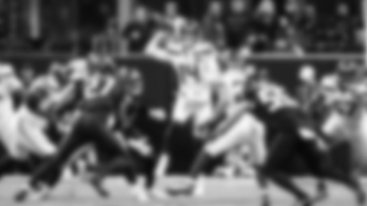 Seahawks quarterback Sam Darnold finds a receiver while being pressured in the pocket.