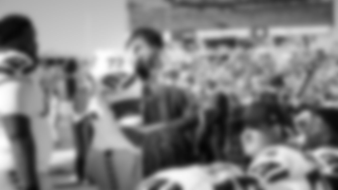 On the sideline, tackle Abraham Lucas talks to his teammates between series.