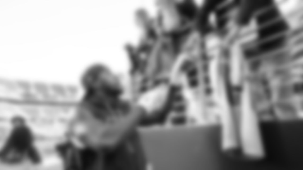 At Levi's Stadium, Derick Hall pauses to sign autographs for the 12s during the early warmup period.