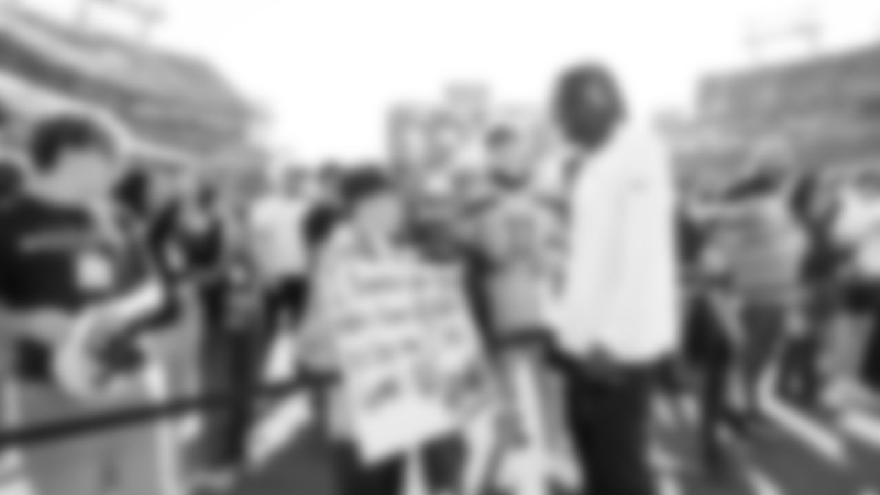 Seahawks cornerback Riq Woolen talks to a young fan before the game.