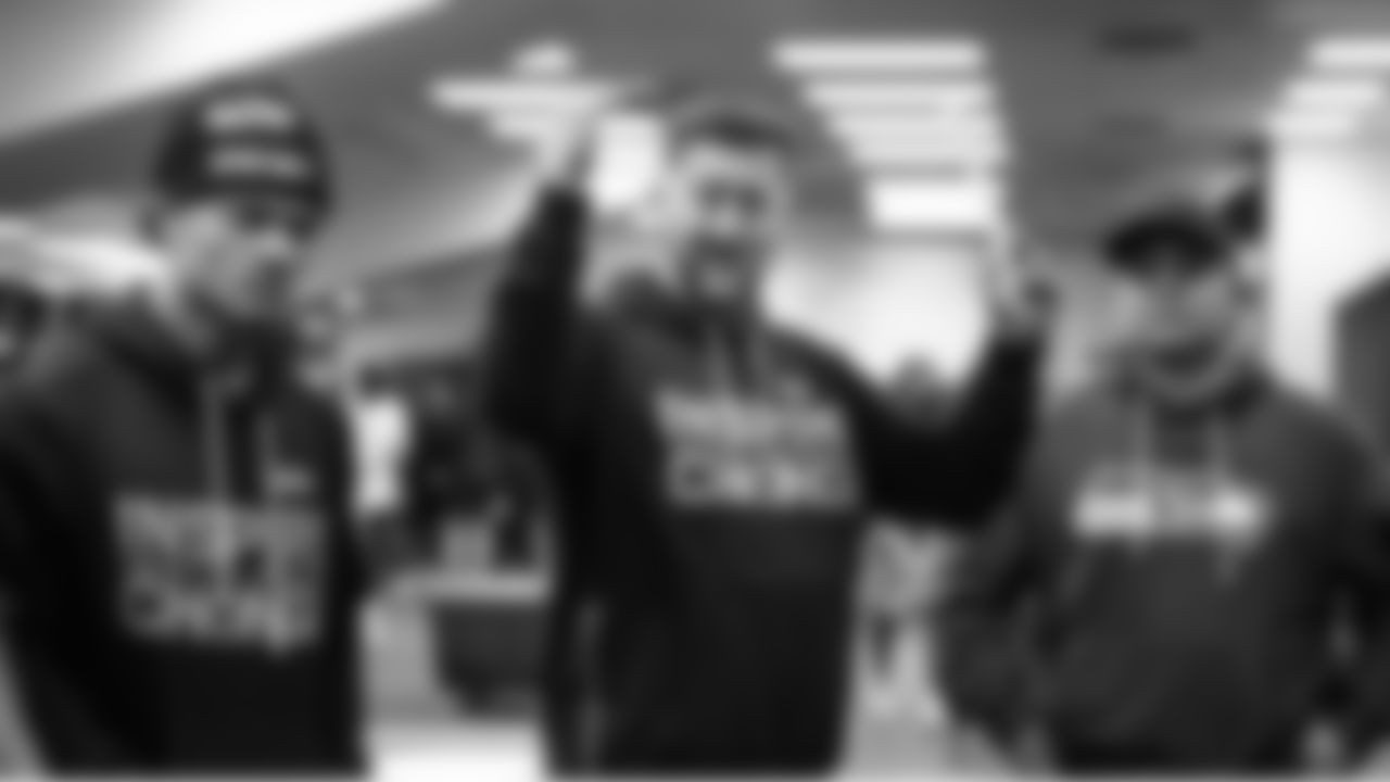 Assistant coach Justin Outten gestures while talking to the running backs including George Holani, left. At right is assistant Michael Byrne.