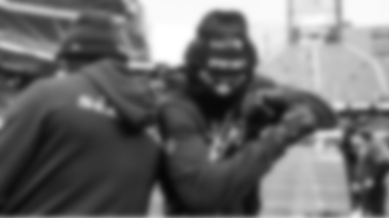 Seahawks receiver Jaxon Smith-Njigba and a teammate greet each other on the field during pregame warmups.