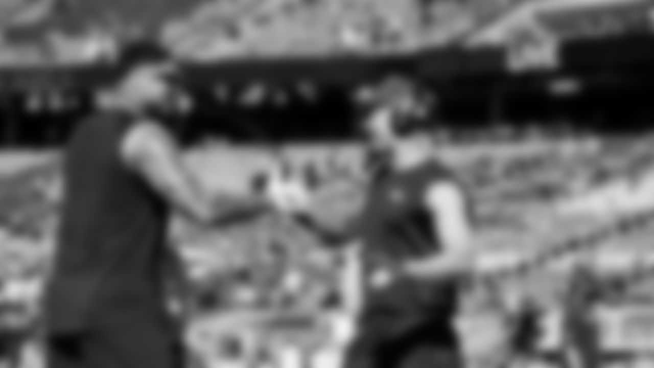 On the field, teammates Elijah Arroyo and Jaxon Smith-Njigba enjoy a moment during early pregame warmups.