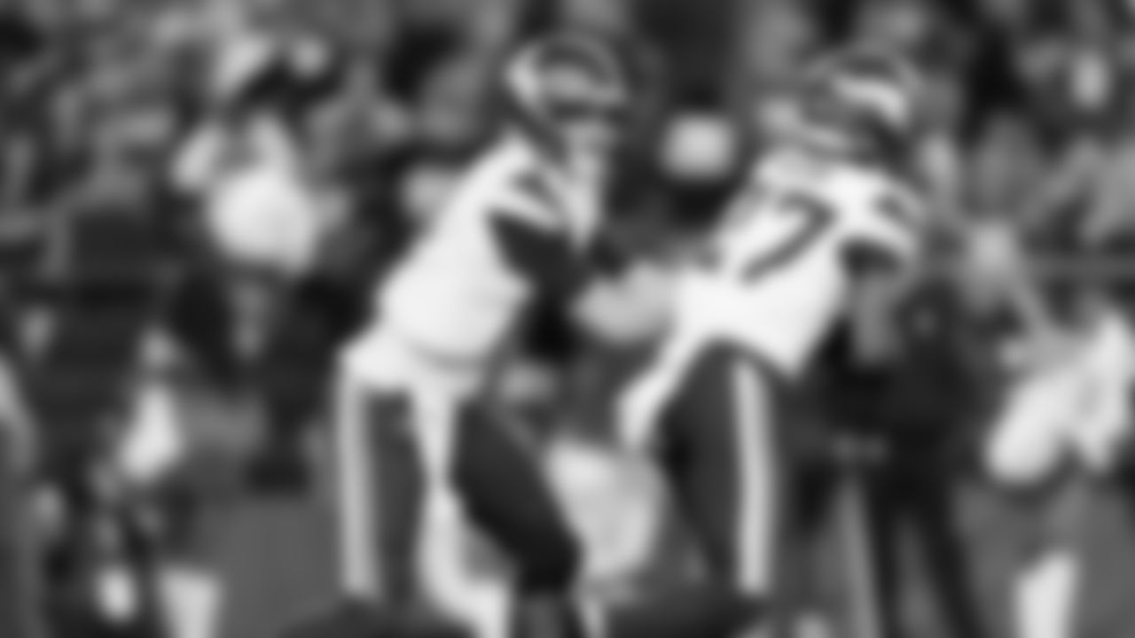 Minnesota Vikings quarterback Sam Darnold (14) hands off the ball to running back Cam Akers (27) during an NFL football wild card playoff game against the Los Angeles Rams, Monday, Jan. 13, 2025 in Glendale, Ariz. (Brooke Sutton via AP)