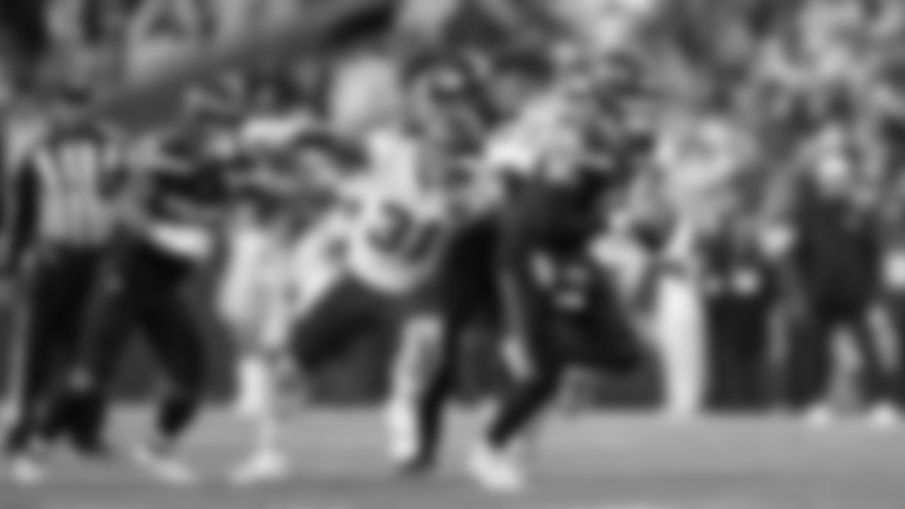 Seahawks quarterback Drew Lock takes off on a long gain in the second quarter.