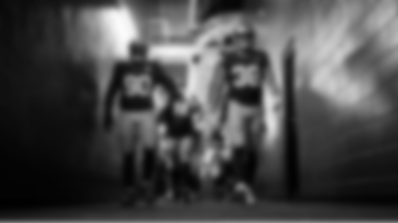 The Seahawks led by Jarran Reed and Brady Russell, head to the field for pregame warmups.