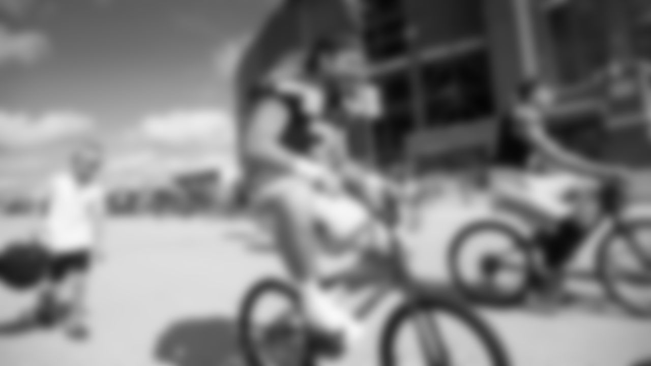 Seahawks fullback Brady Russell (38) rides a bike on their way to practice on August 21, 2025 in Green Bay, Wisconsin.