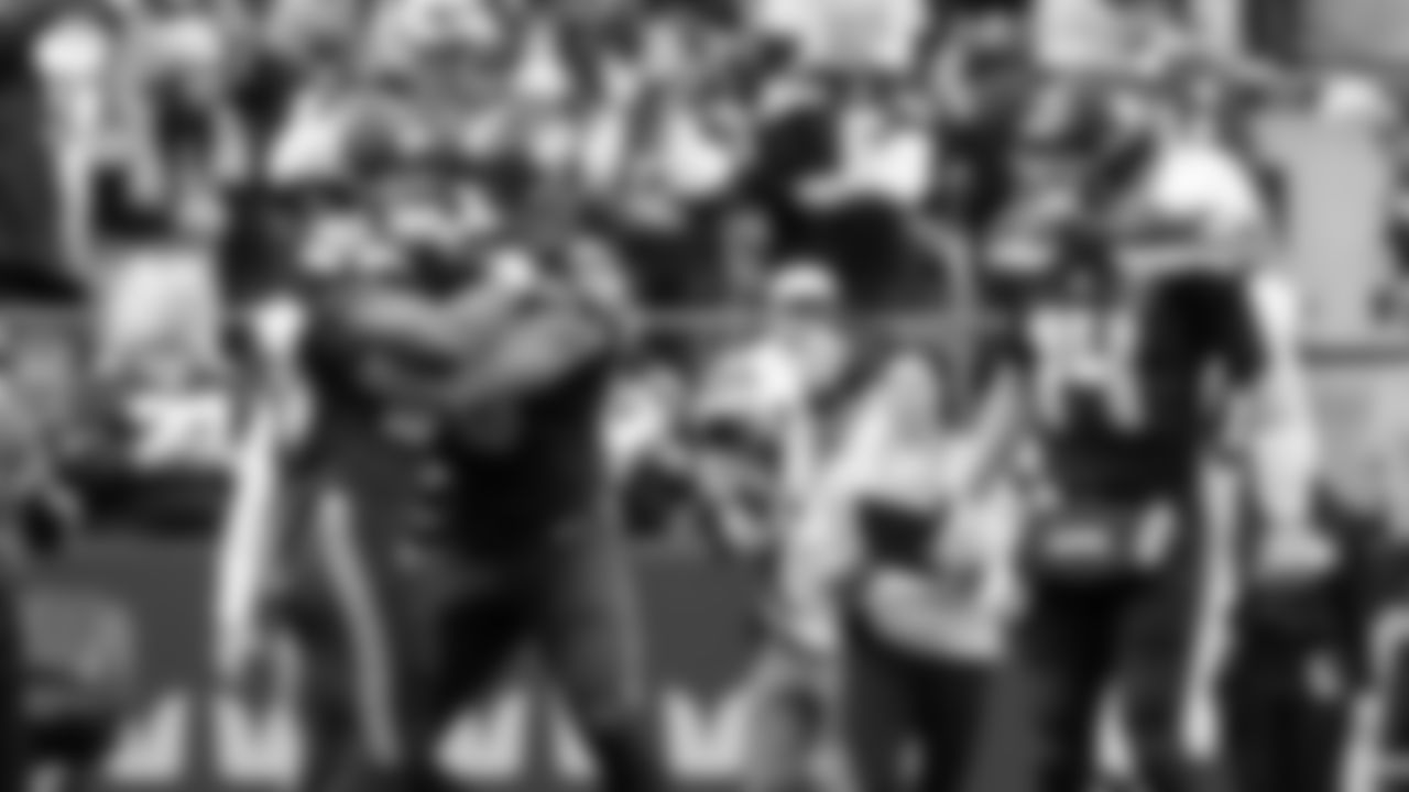 Seahawks running back George Holani celebrates his touchdown with teammates Brady Russell and Sam Darnold.