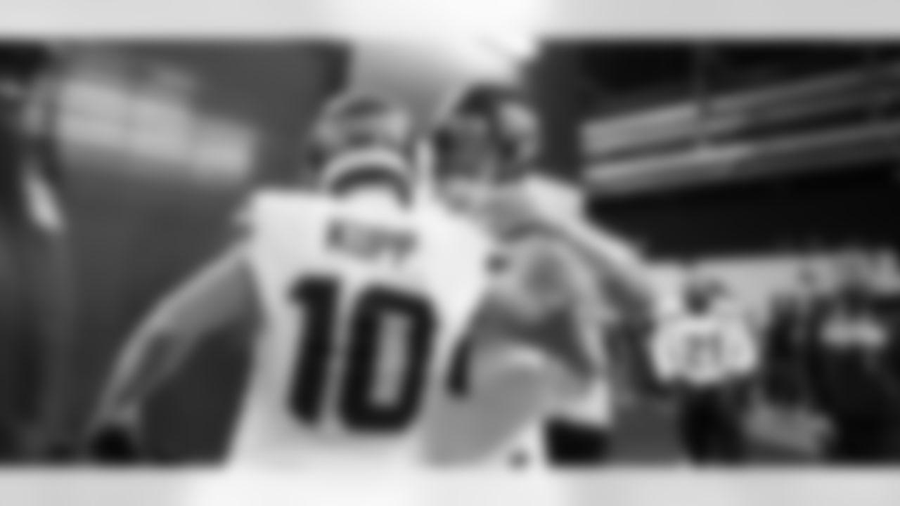 Quarterback Sam Darnold greets receiver Cooper Kupp in the tunnel before taking the field.