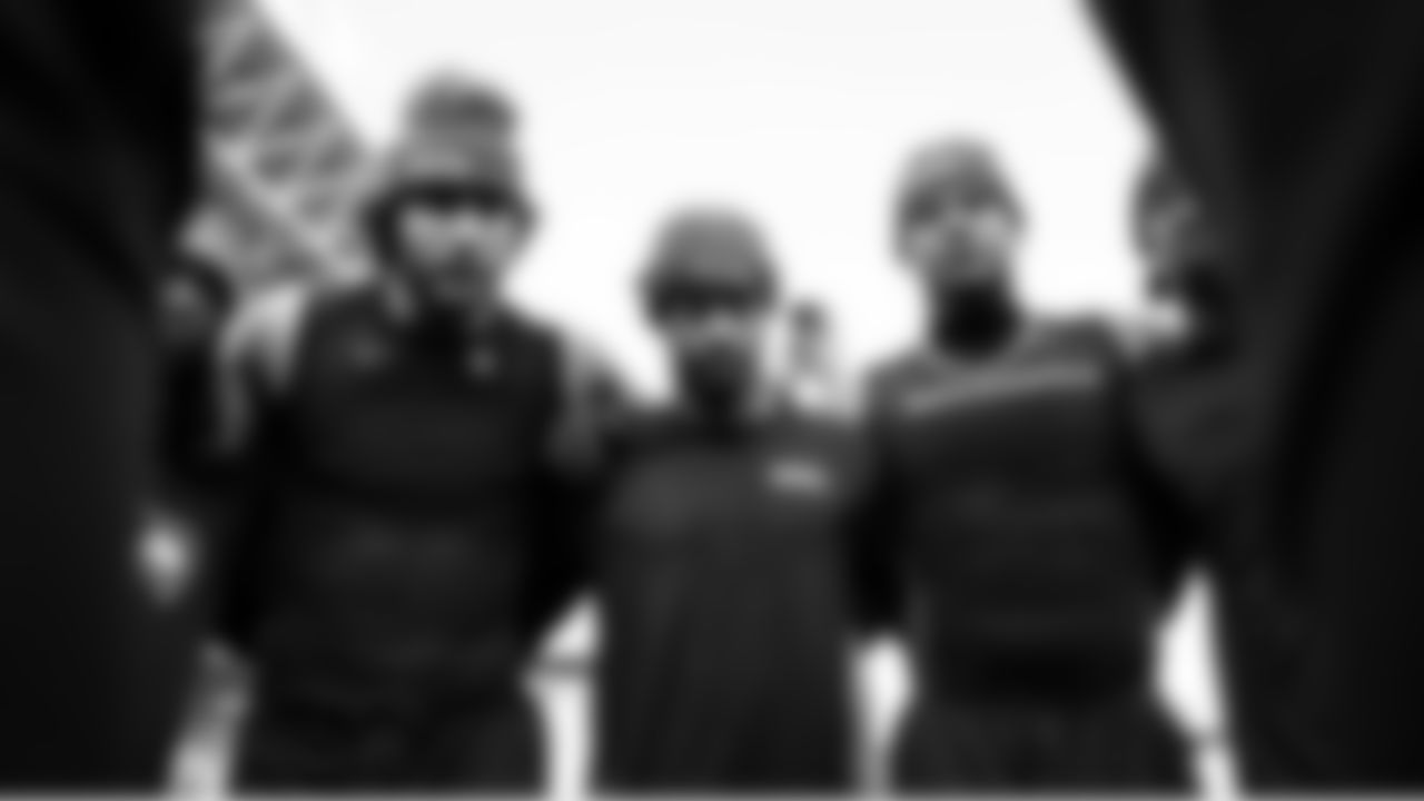 Seahawks AJ Barner, Jaxon Smith-Njigba and Elijah Arroyo listen as quarterback Sam Darnold speaks to the skill players.