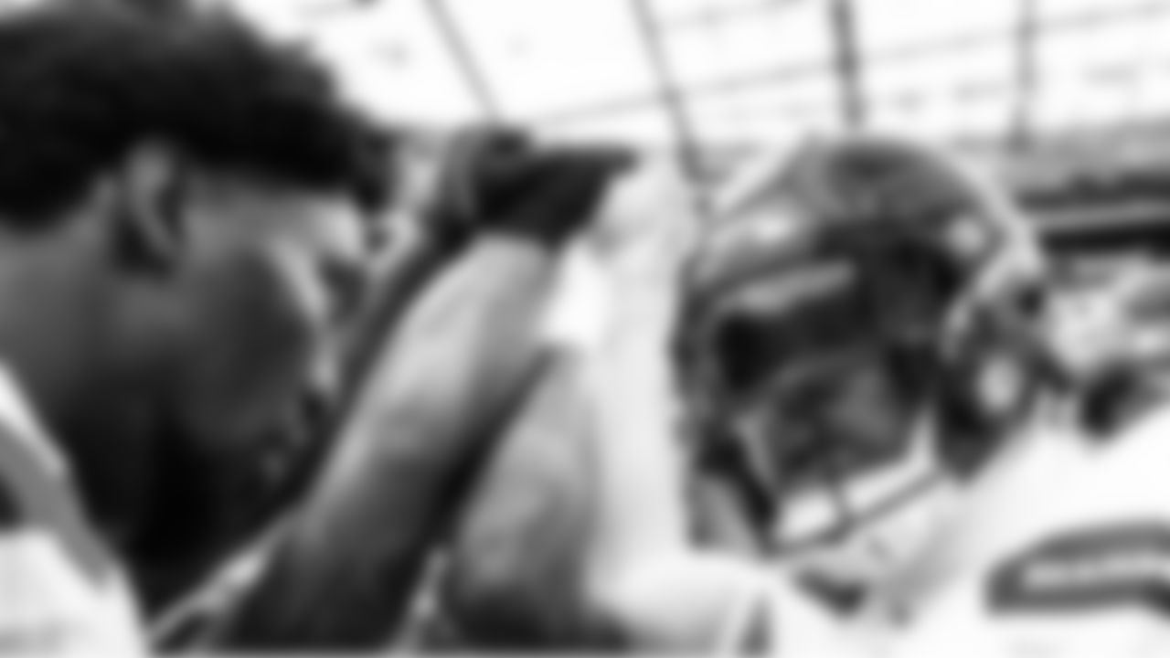 Seahawks defenders, including DeMarcus Lawrence and Uchenna Nwosu, gather during pregame.