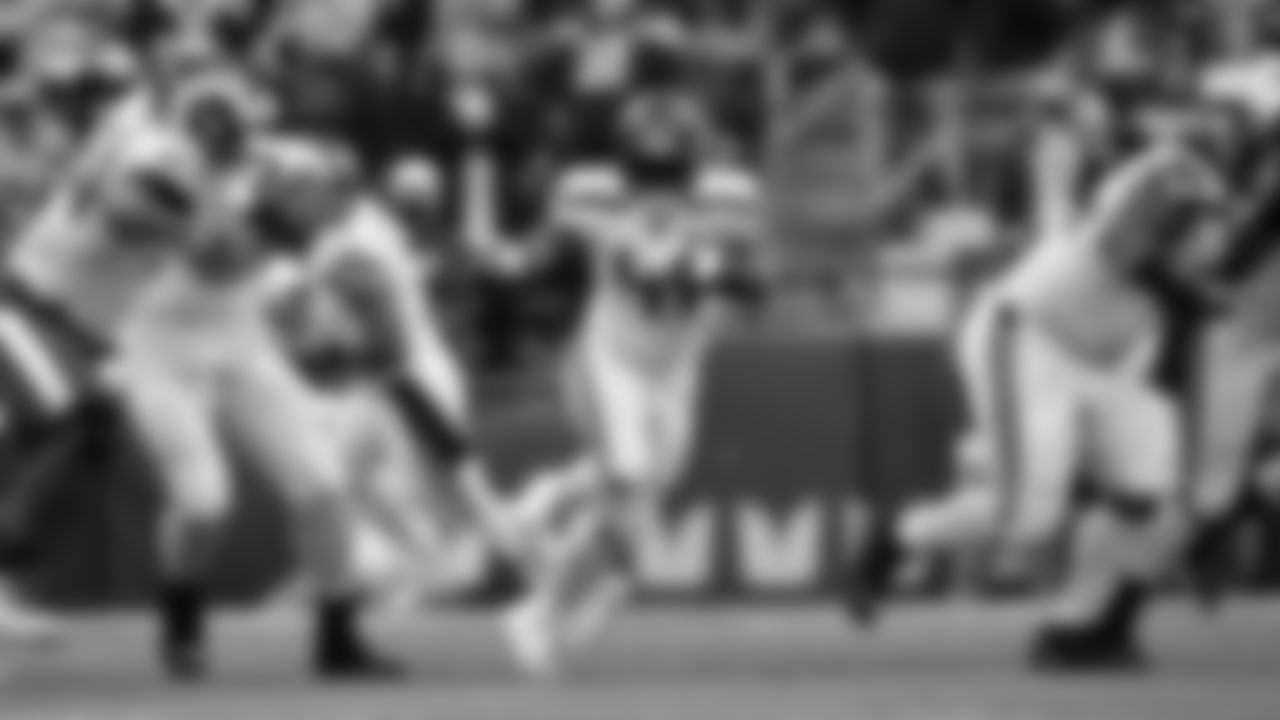 Seahawks running back Alex Collins breaks through an opening.