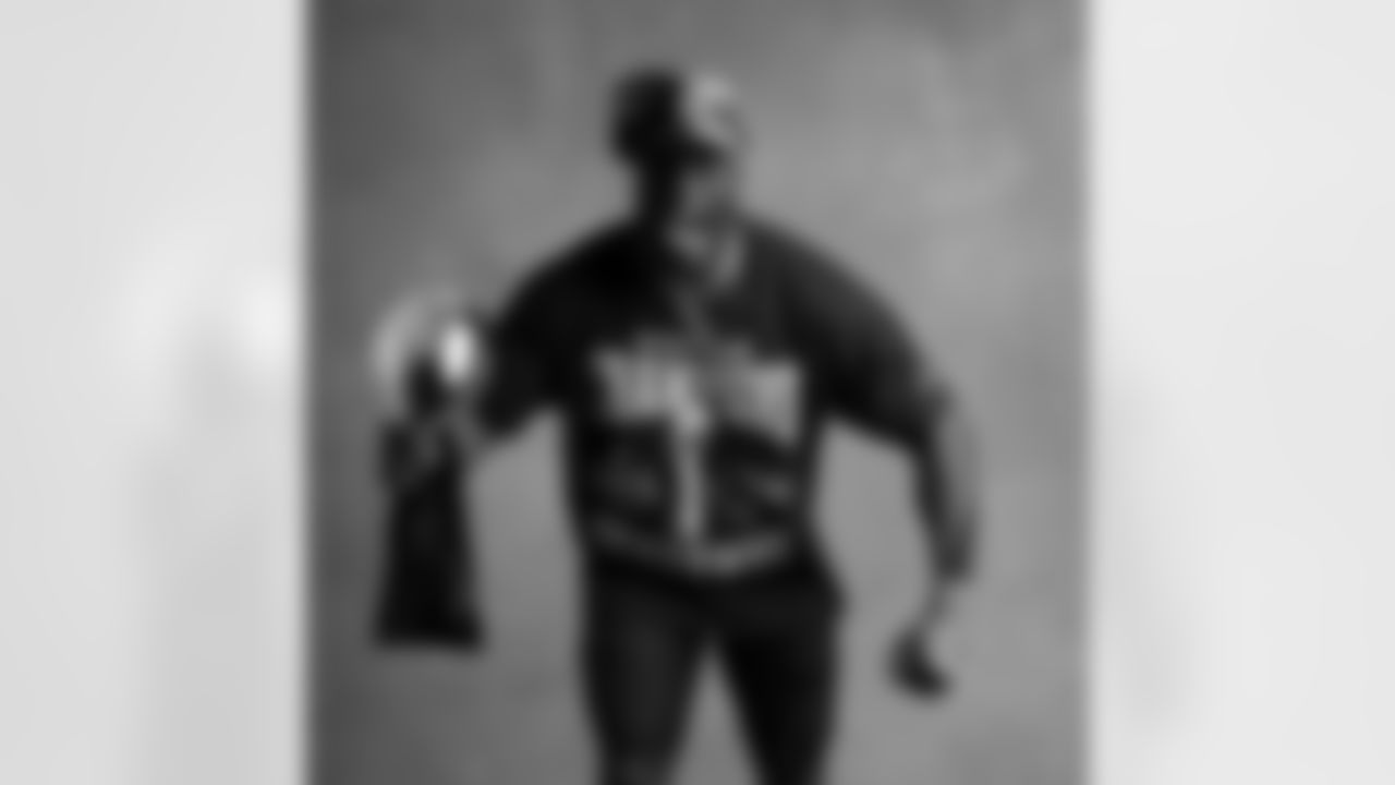 Seahawks linebacker Derick Hall (58) with the Lombardi Trophy after winning Super Bowl LX.