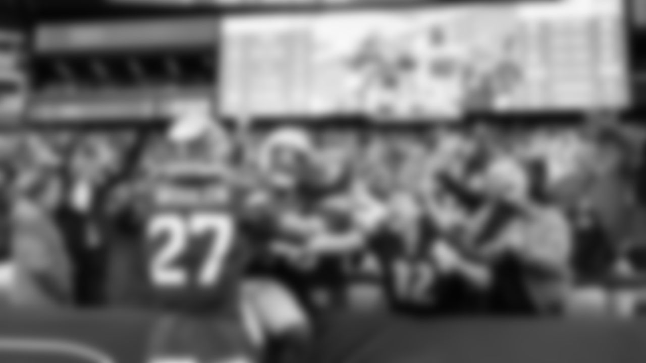 Ernest Jones IV celebrates with teammate Riq Woolen and the 12s in the south end zone after his pick-six.