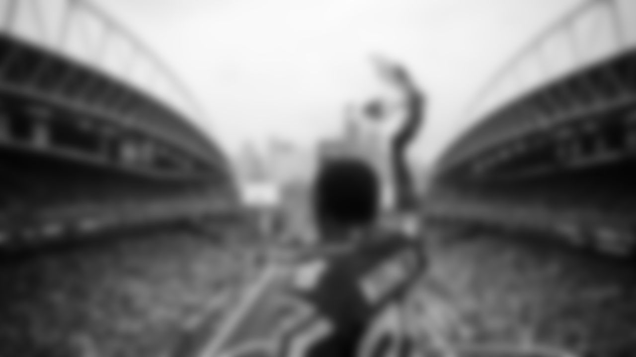Seahawks Legend Curt Warner raises the 12 Flag before the 2nd preseason game against the Chiefs on August 15th.