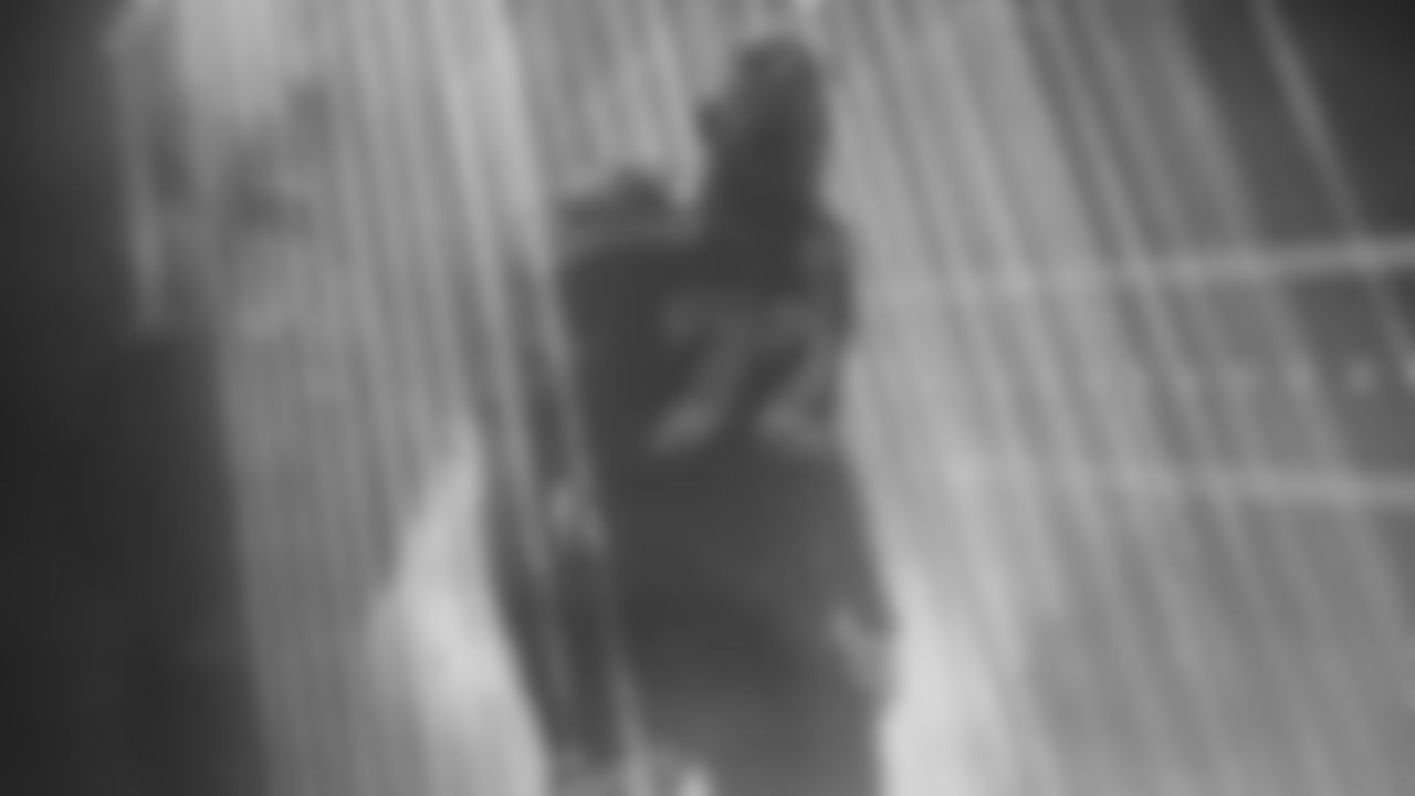 Seahawks right tackle Abraham Lucas heads through the fog and lasers in the tunnel leading from the locker room to the field.