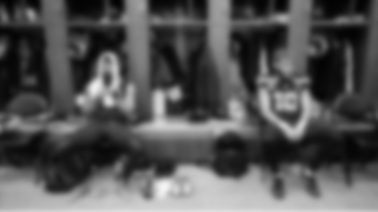 Receivers Jaxon Smith-Njigba and Cooper Kupp sit at their lockers waiting for game time.