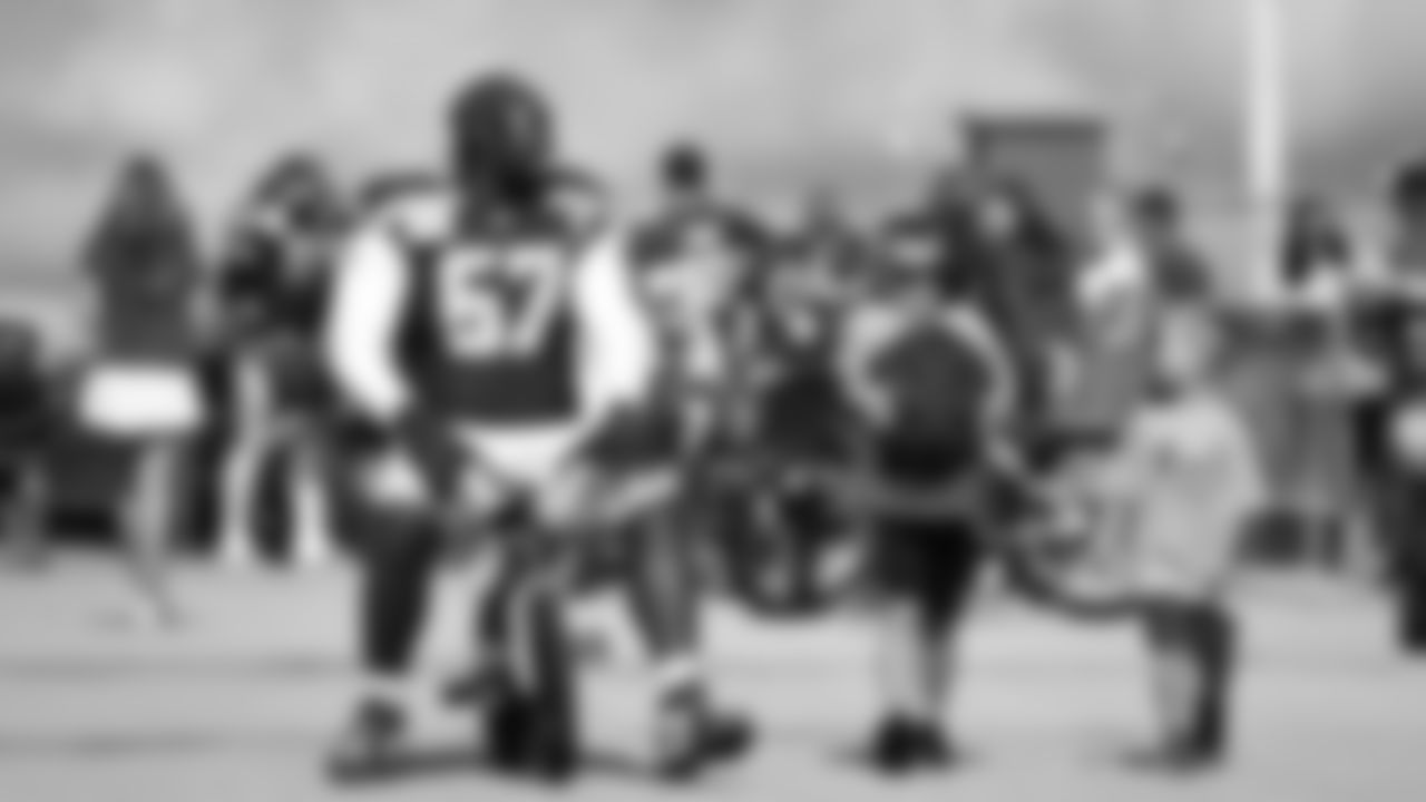 Seahawks tackle Charles Cross (67) rides a bike on their way to practice on August 21, 2025 in Green Bay, Wisconsin.