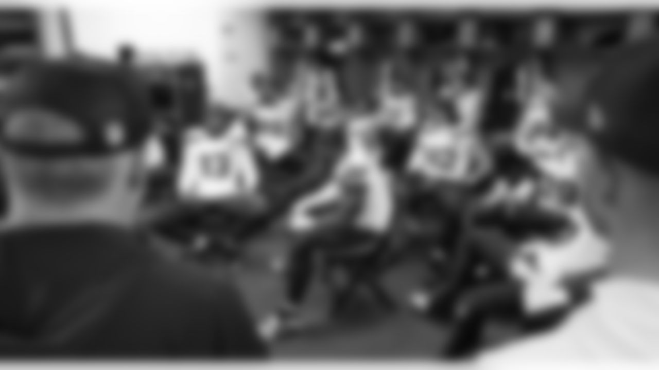 At the other end of the locker room, the defense rests before meeting with their coaches.