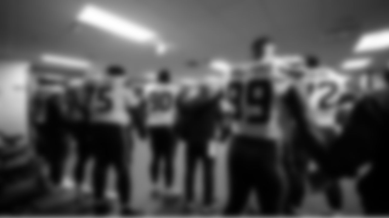 The Seahawks join hands in prayer before leaving the locker room.