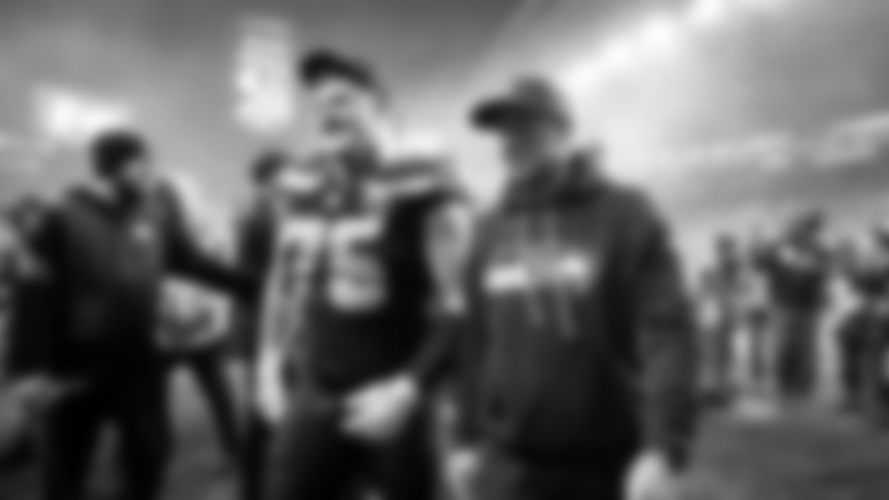 Seattle offensive guard Grey Zabel and offensive coordinator Klint Kubiak walk off the field together after the win.