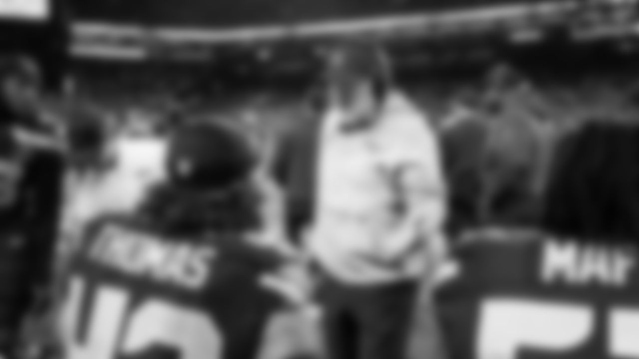 Assistant coach Kirk Olivadotti talks with linebackers on the sidelines.