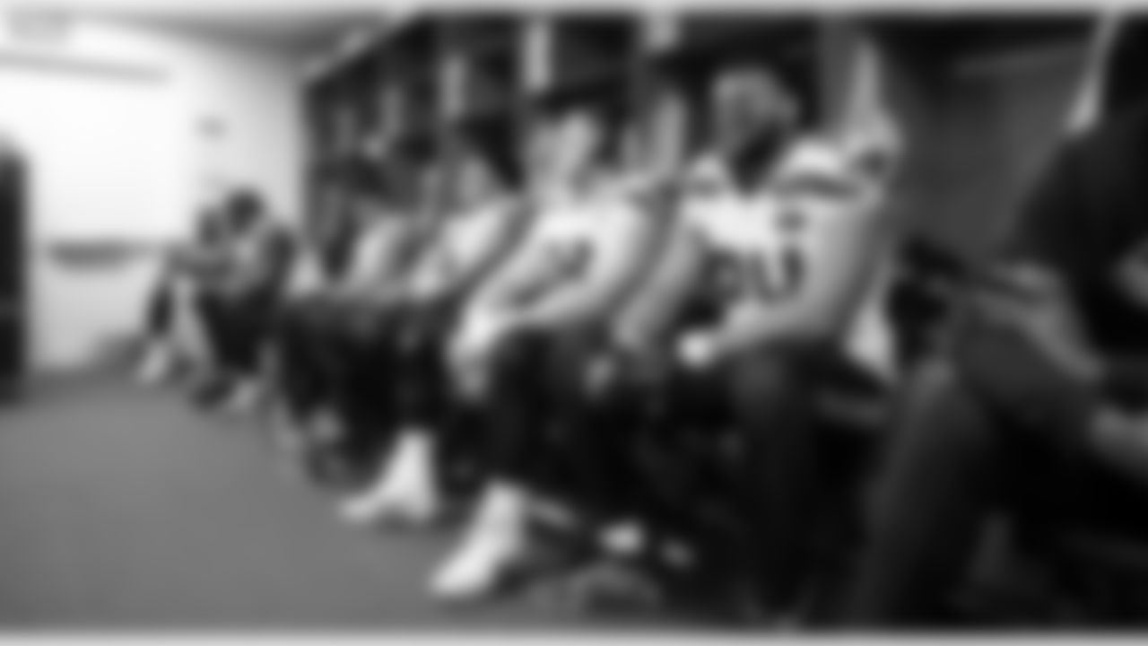 On the other end of the locker room, the defensive line waits to leave for kickoff.