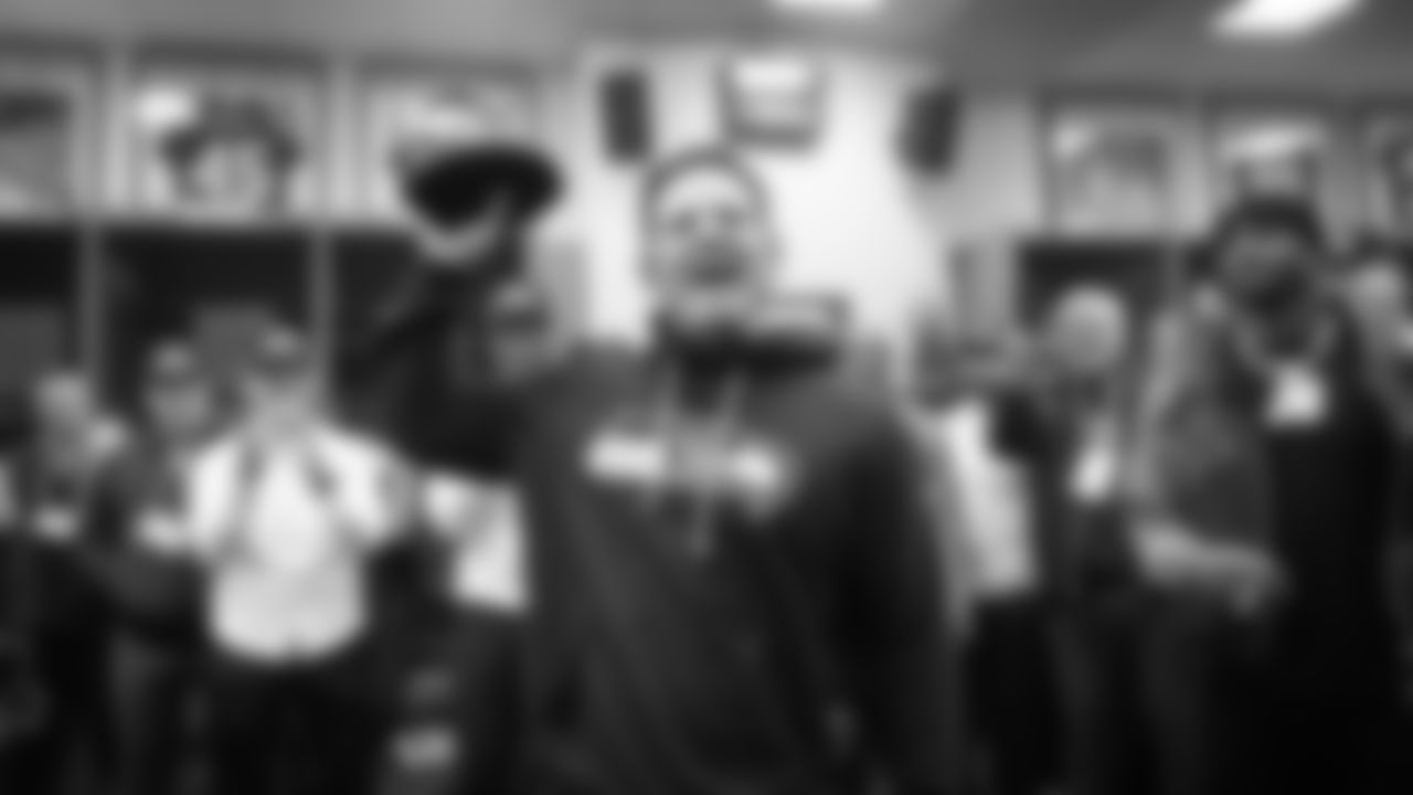 Head coach Mike Macdonald celebrates the NFC title with his team in the locker room.