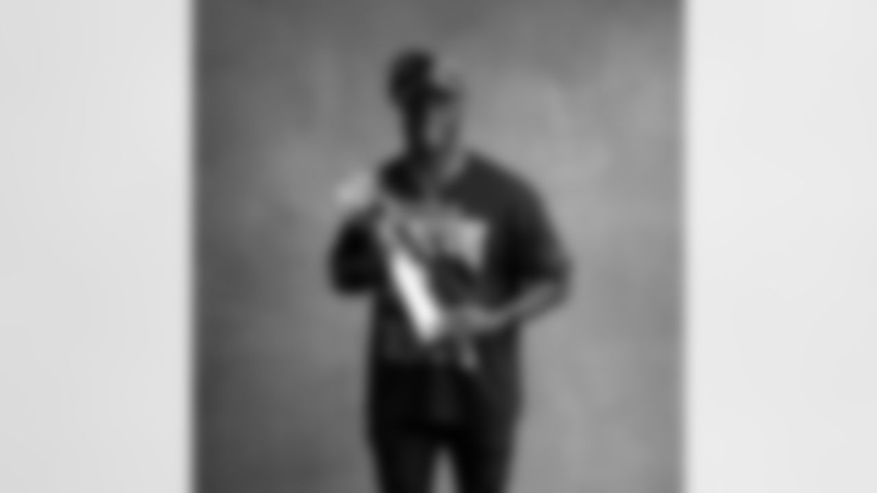 Seahawks linebacker Derick Hall (58) with the Lombardi Trophy after winning Super Bowl LX.