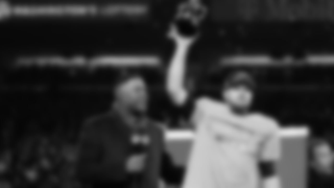 Seattle Seahawks quarterback Sam Darnold, lifts the winner's trophy next to Michael Strahan, left, and chair Jody Allen, right, after a win over the Los Angeles Rams in the NFC Championship NFL football game Sunday, Jan. 25, 2026, in Seattle. (AP Photo/Godofredo A. Vásquez)