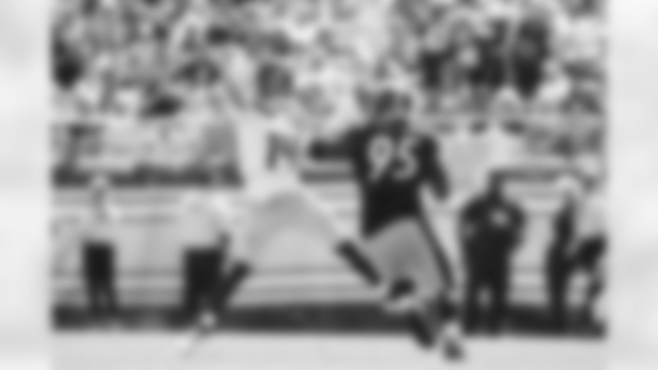 Seahawks quarterback Sam Darnold throws on the run.