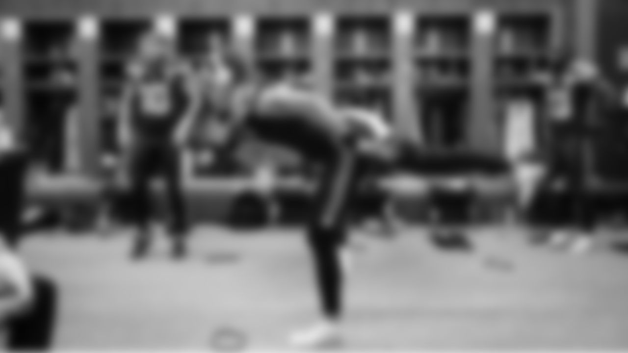 Receiver Jake Bobo stays loose as players stretched and moved during the unusually long halftime break.