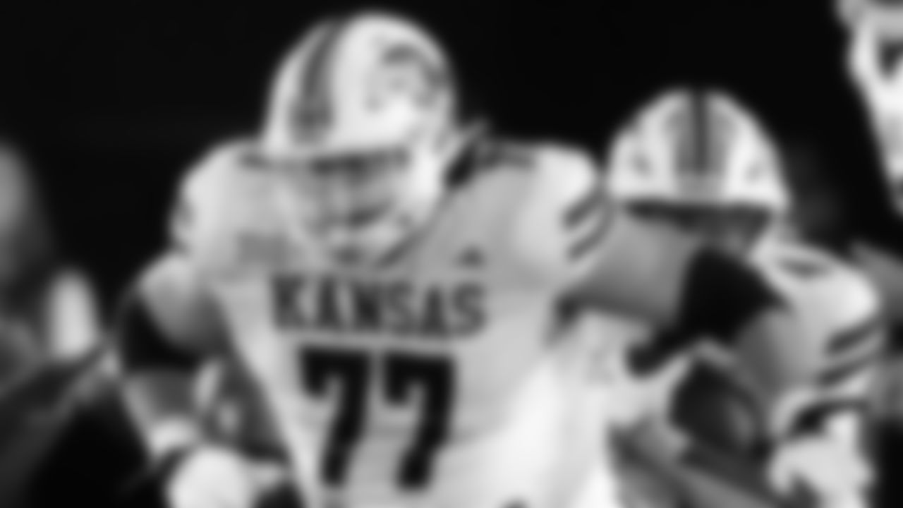 Kansas offensive lineman Bryce Cabeldue (77) looks to make a block during the second half of an NCAA college football game against Iowa State, Saturday, Nov. 4, 2023, in Ames, Iowa. Kansas won 28-21. (AP Photo/Charlie Neibergall)