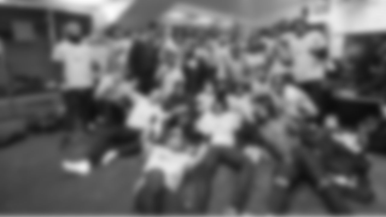 Members of the Seahawks defense pose together with the George Halas trophy in the locker room after the game.