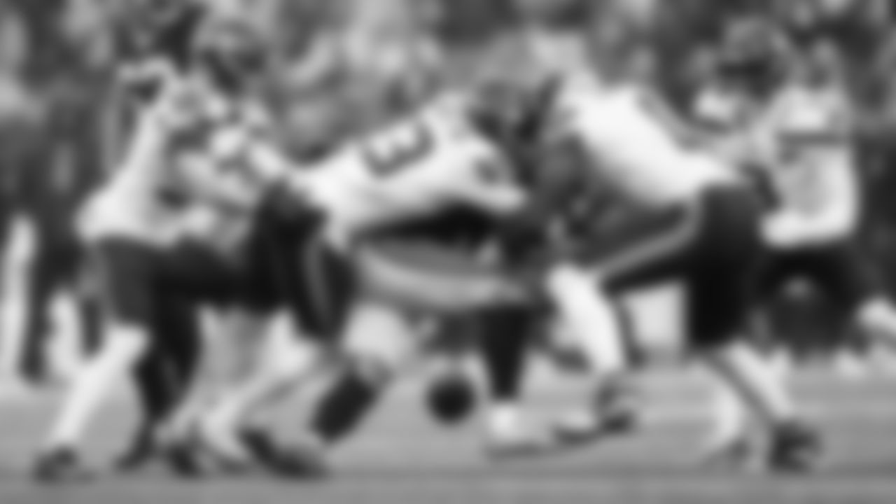 Seahawks linebacker DeMarcus Lawrence forces a fumble that he recovered as Ernest Jones IV helps with the tackle.