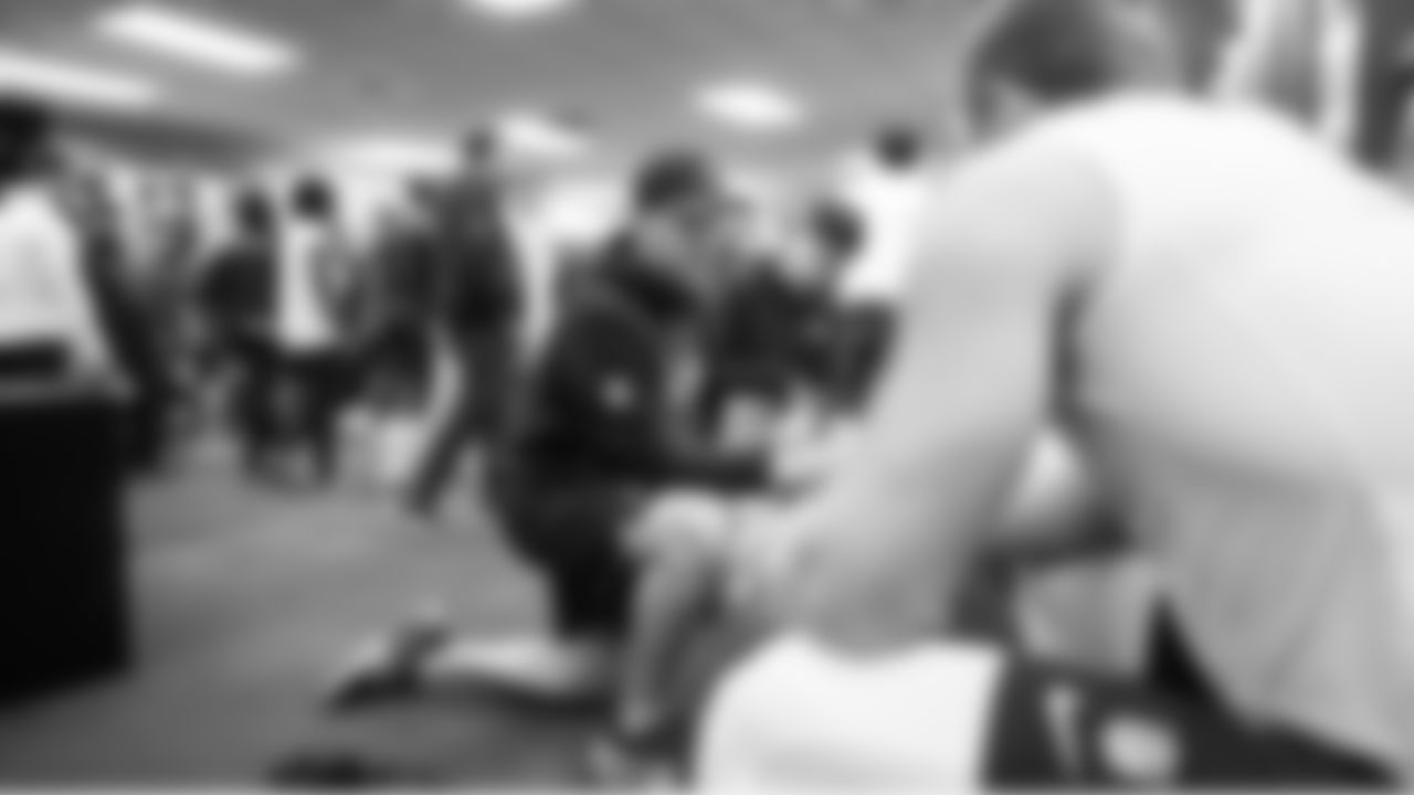 In the locker room on game day, tight ends coach Mack Brown talks to his position players.