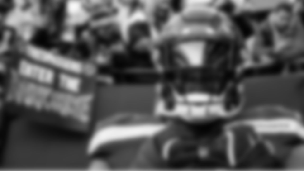 The arches of Lumen Field are reflected in the dark visor of Seattle's Jarran Reed.