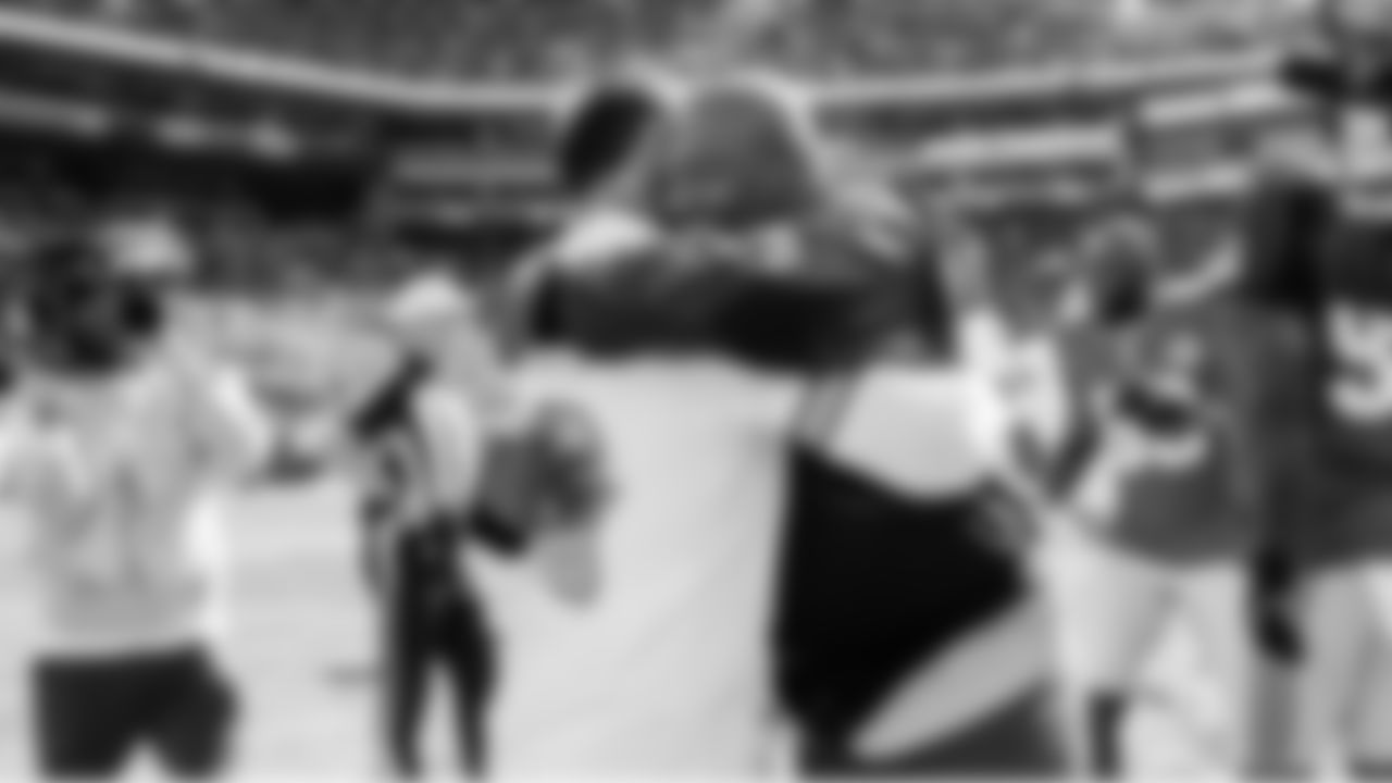 Seahawks Legend Shaun Alexander hugs Buccaneers Legend Mike Alstott at midfield as both were honorary captains for the pregame coin toss.