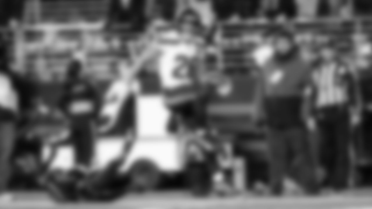 Seahawks running back Zach Charbonnet leaps into the end zone for a touchdown.