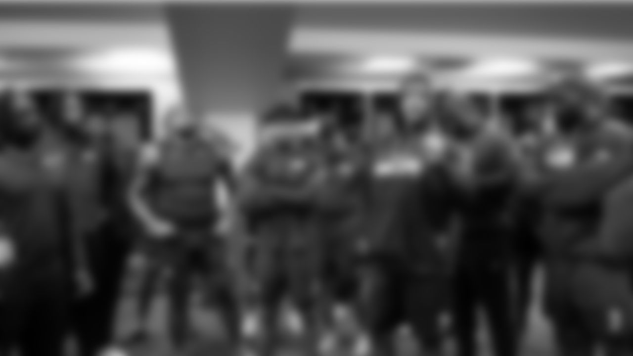 Members of the Seahawks defense listen to defensive coordinator Aden Durde.